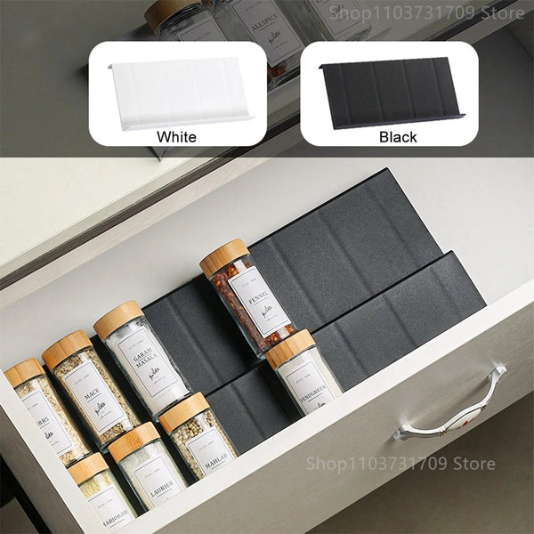 Black drawer spice organizer with tiered rows of seasoning bottles